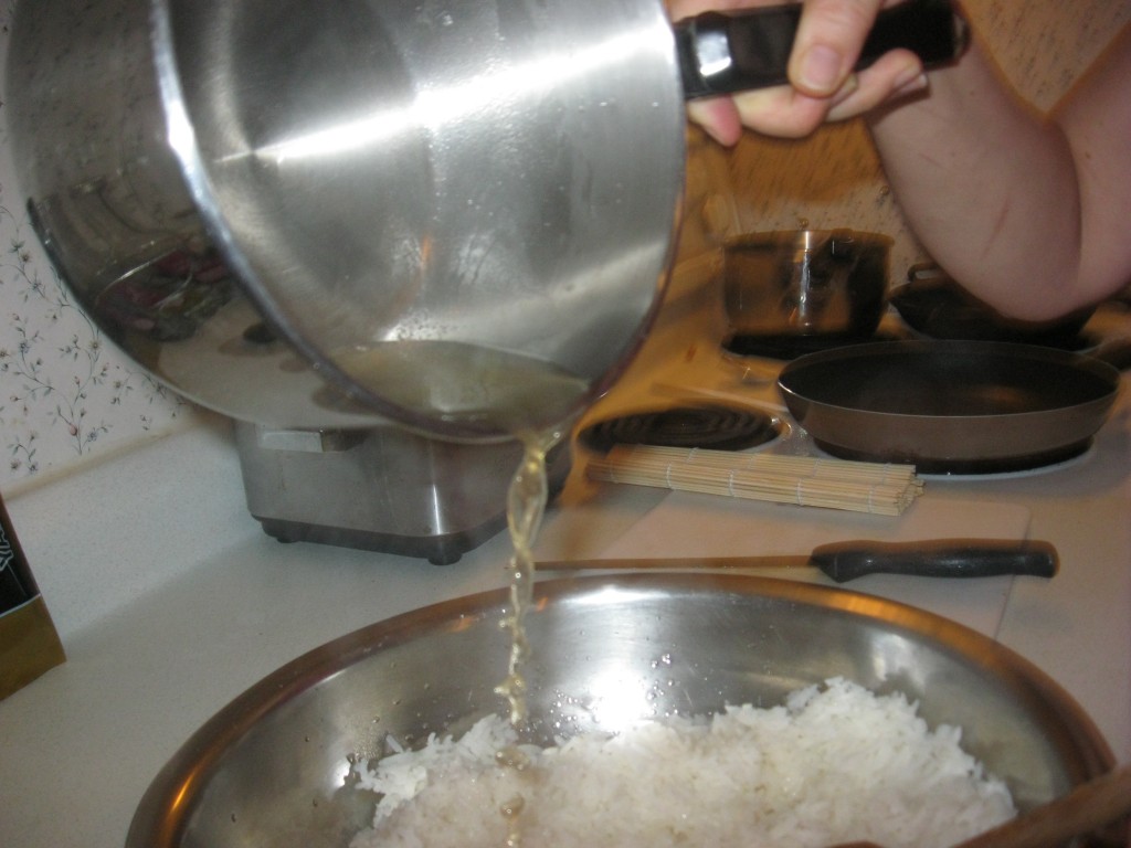 add the rice vinegar mixture to the cooked rice